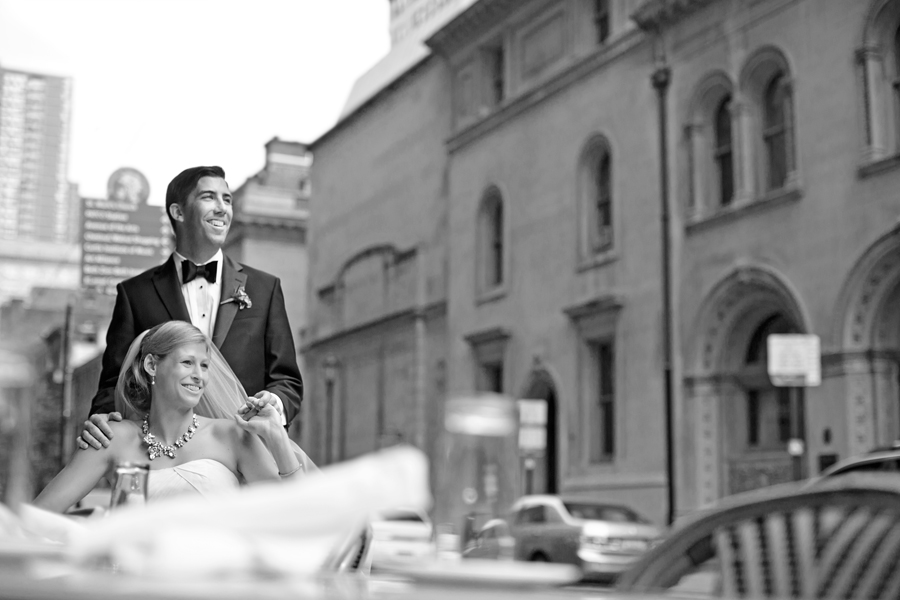 bride and groom sitting at cafe prior to wedding reception